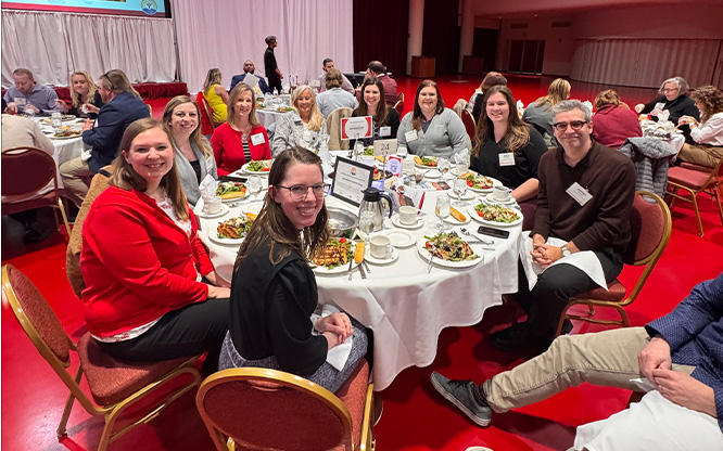 A group of Ascendium employees seated at a dinner table. 